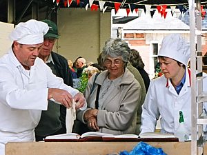 Photo: Paul shows dough to visitor; Gail observes