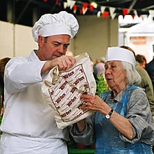 Photo: Paul examines customer's bread bag